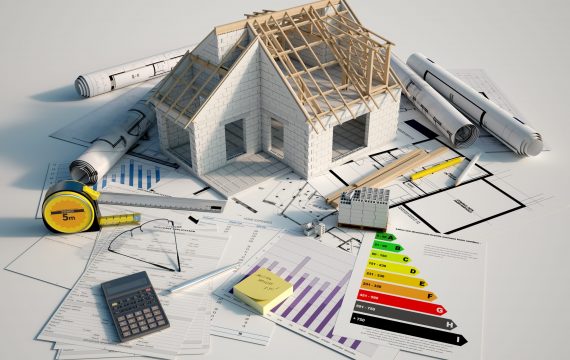 3D renderin of a house under construction on top of blueprints, mortgage forms and a energy efficiency chart